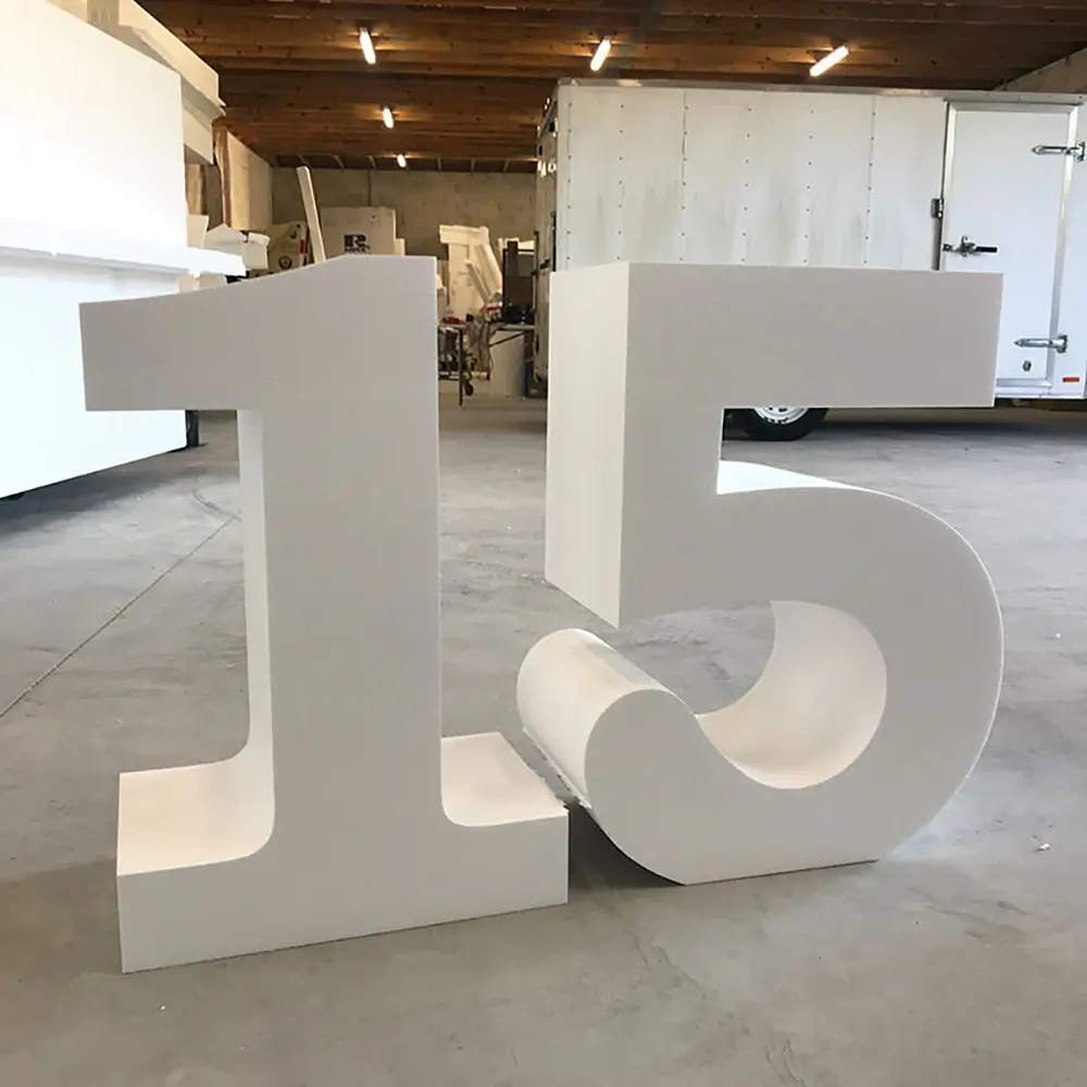 Large white dimensional numbers 1 and 5 in warehouse production space