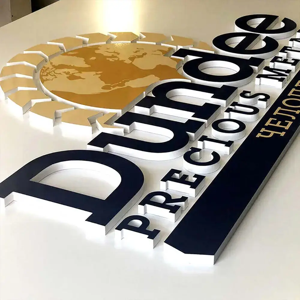 Layered black, white, and gold acrylic corporate logo with a world map graphic