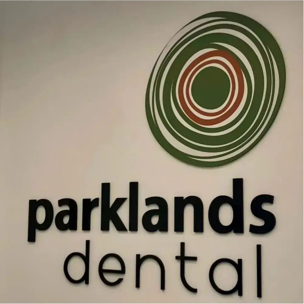 Parklands Dental black acrylic wall letters beneath a green and red circular logo