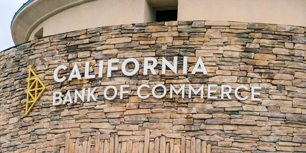 California Bank of Commerce dimensional letters mounted on curved stone wall