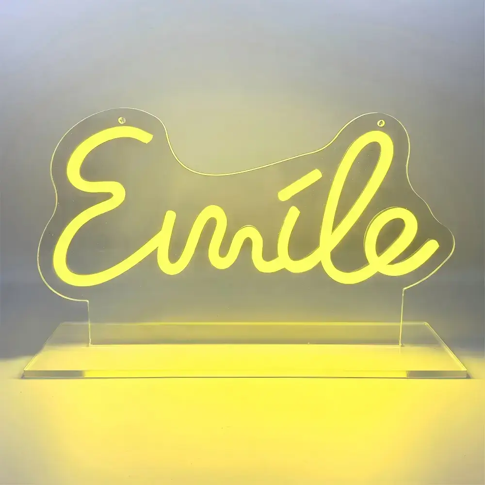 Yellow Smile LED neon sign displayed on a clear acrylic tabletop stand