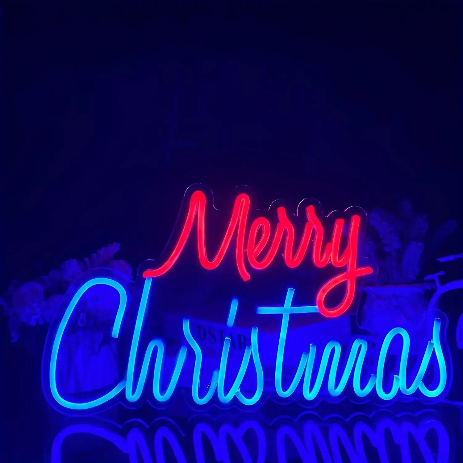 Red and blue Merry Christmas LED neon sign glowing at night