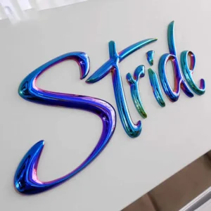 Iridescent chrome script letters spelling "Stride" mounted on wall