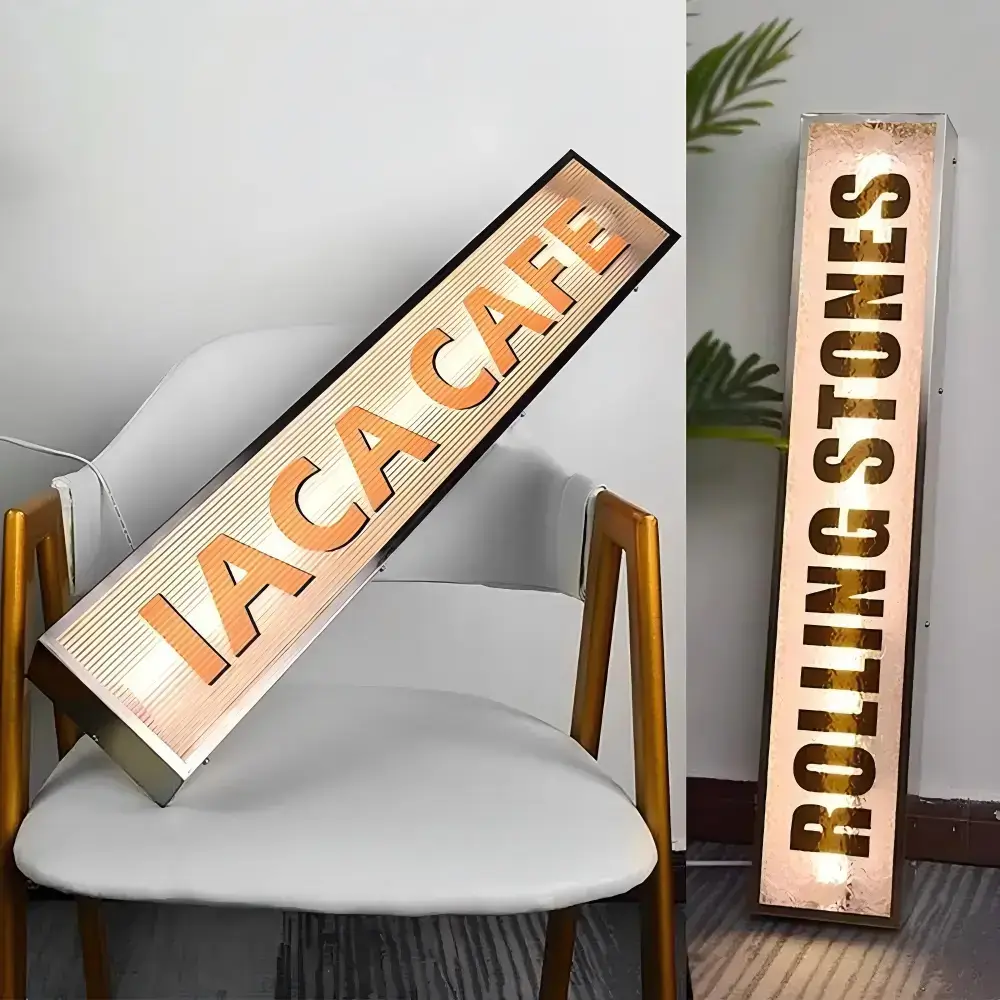 Two illuminated light boxes with fluted glass panels and vertical café lettering