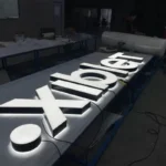 Xiblet white LED channel letters being tested and lit up in the factory workshop