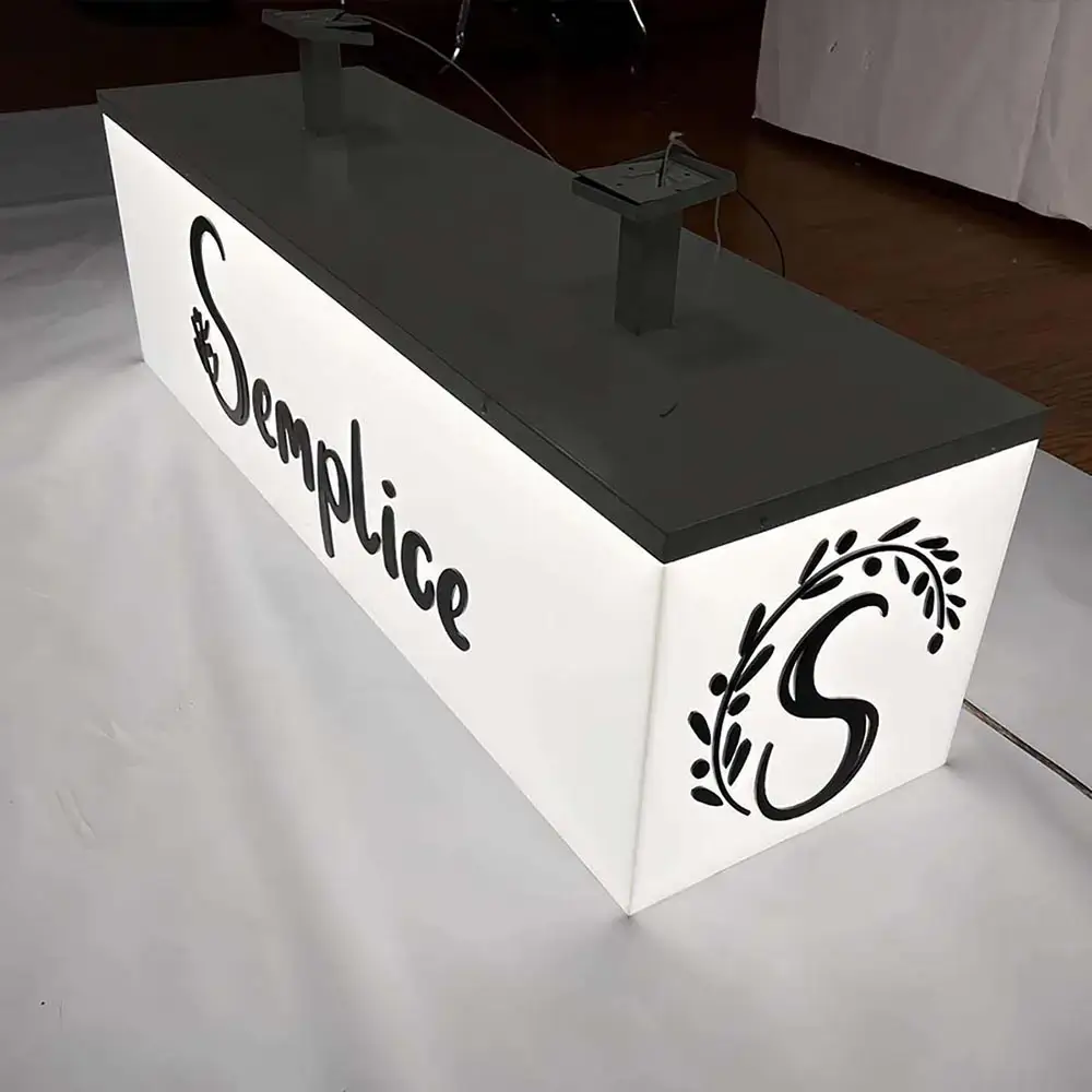 Rectangular illuminated light box with white faces and black graphics prepared for ceiling suspension