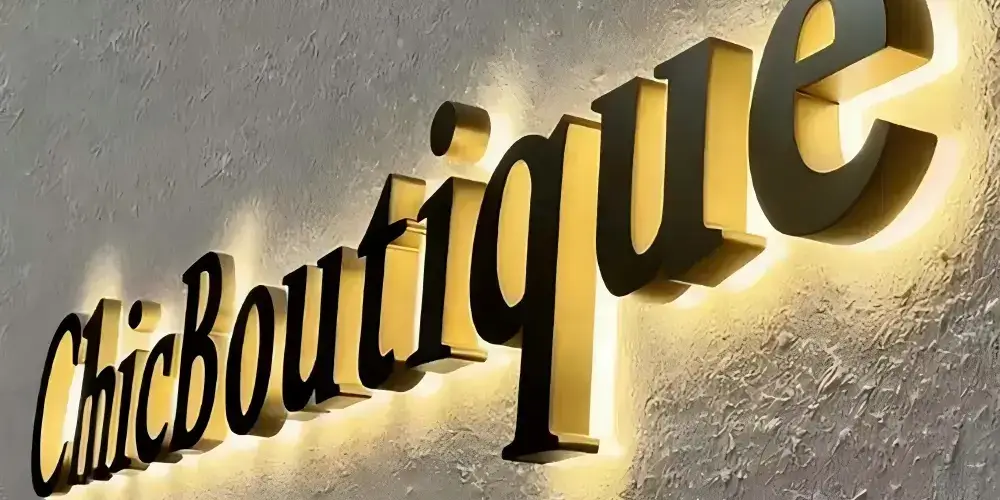 Stainless steel backlit ChicBoutique letters with warm halo lighting