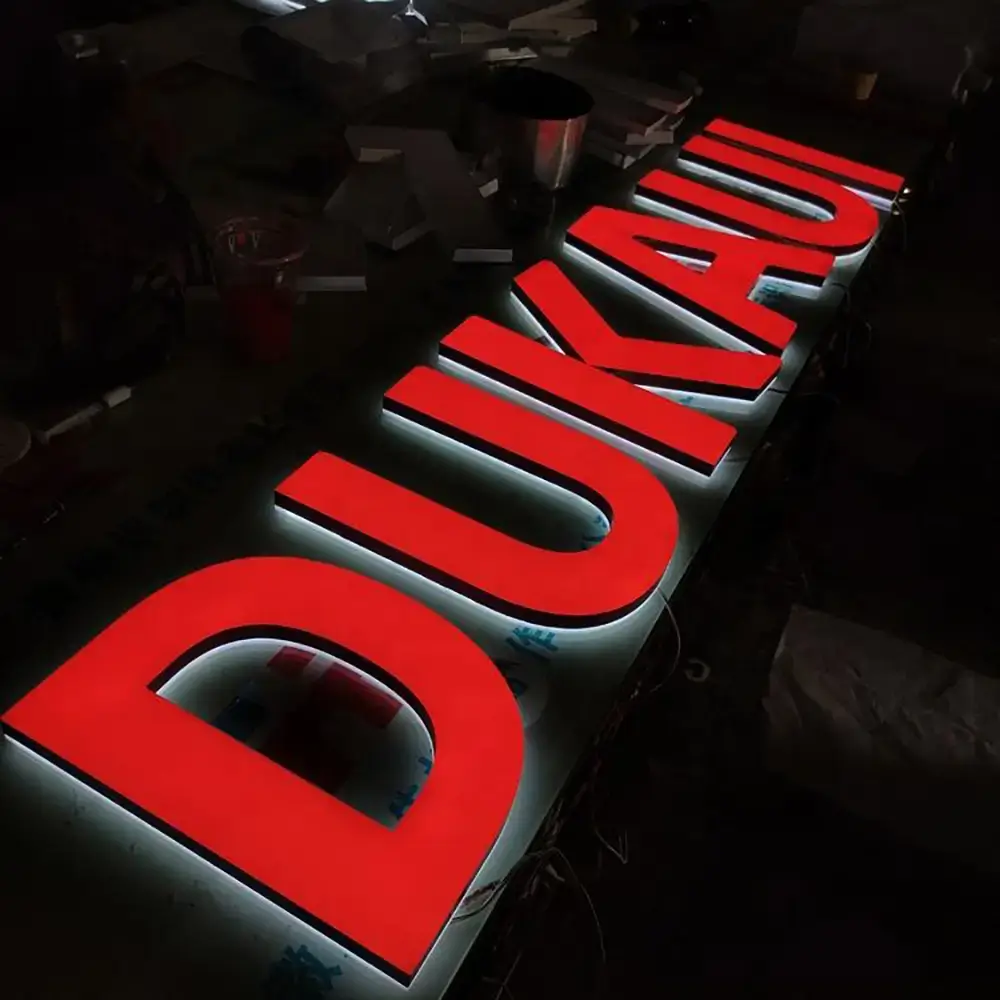 Red liquid acrylic letters with stainless steel returns and rear halo
