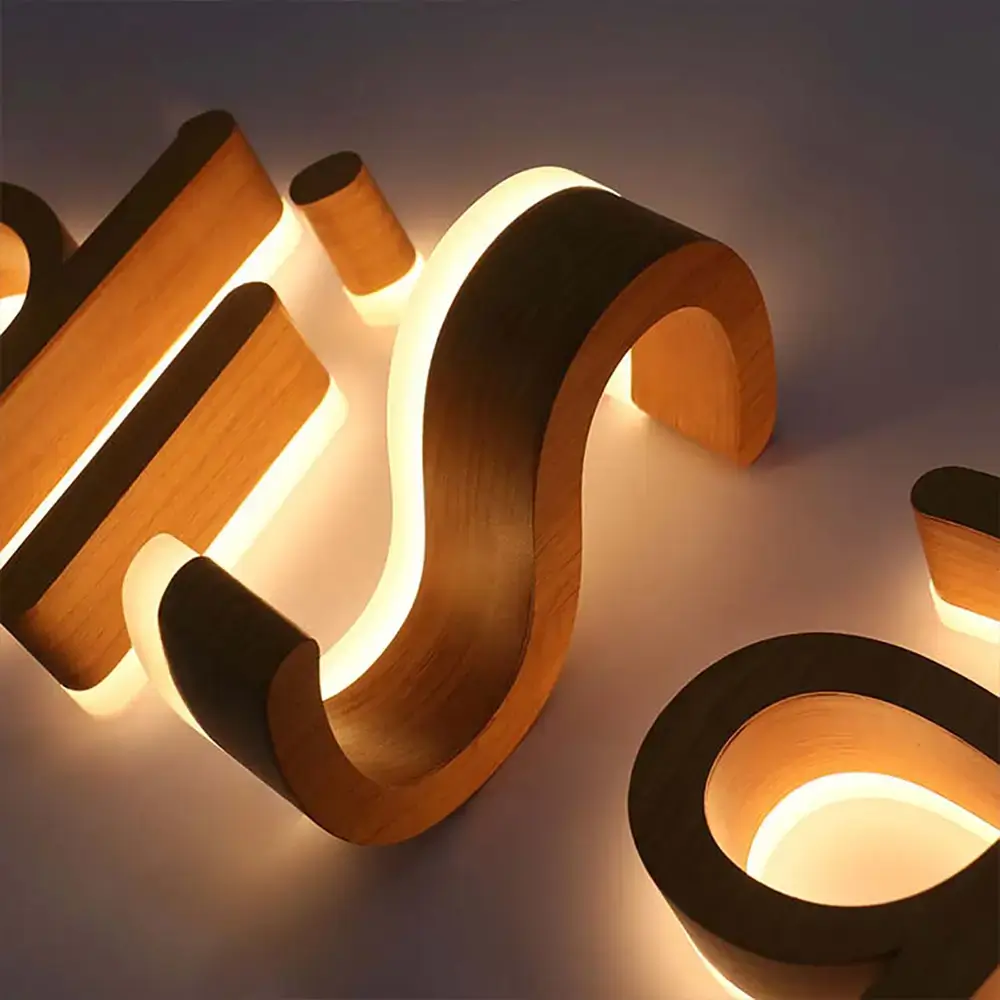 Close-up of wood backlit letters with warm halo illumination