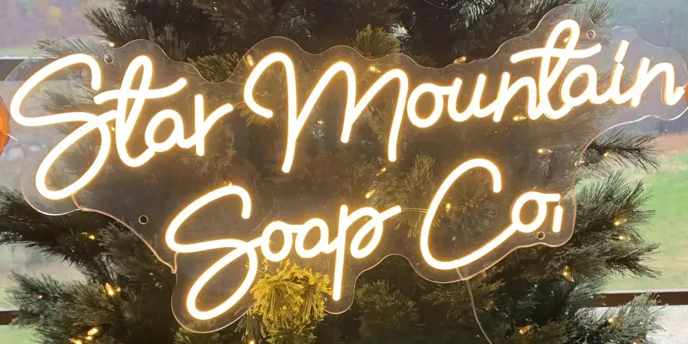 Warm-white Star Mountain Soap Co. custom LED neon sign on clear acrylic