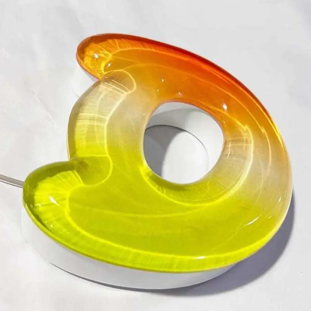 Polished transparent acrylic component with an orange-to-yellow color gradient