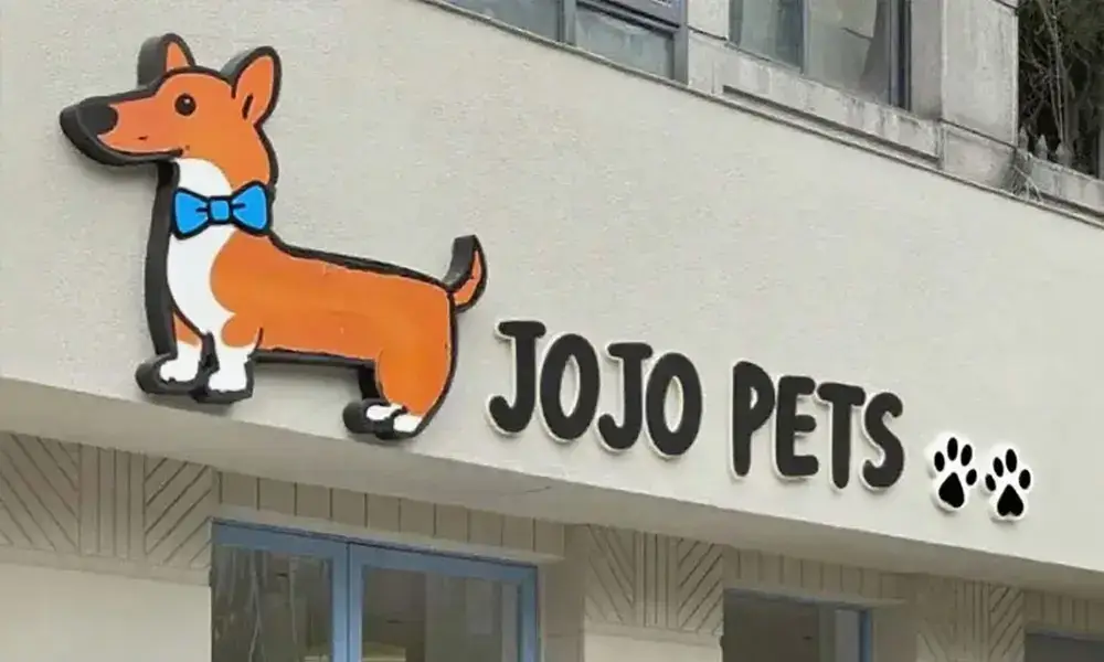 JOJO Pets storefront sign with orange corgi dog character and paw print icons