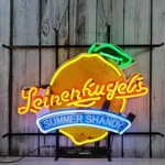 Illuminated lemon sign with yellow lettering and blue Summer Shandy banner