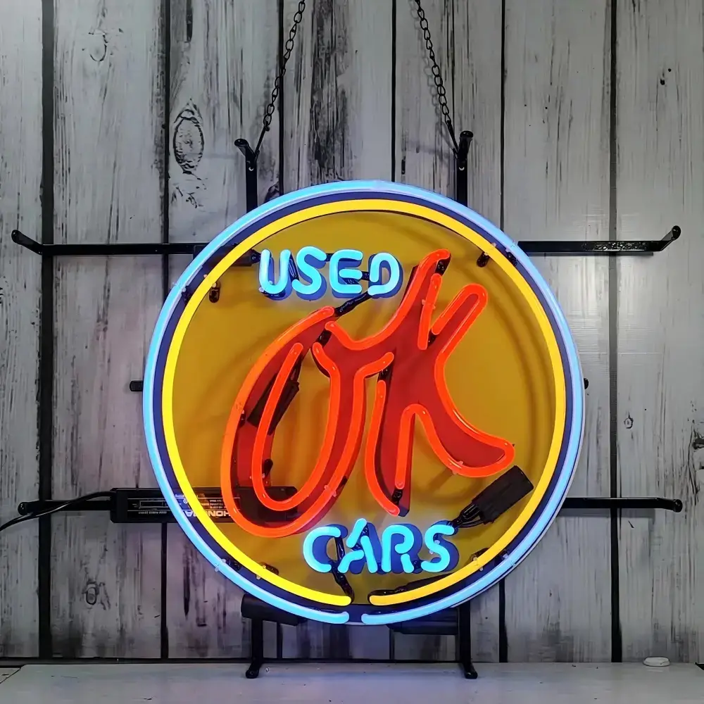 Round Used Cars glass neon sign with orange hand symbol and blue lettering